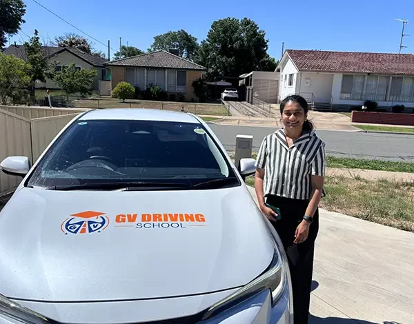 Student and driving instructor celebrating probationary licence success